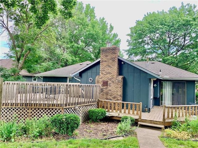 308 NW Shamrock Ave, Lees Summit, MO 64081 - rear view of house featuring board and batten siding, a deck, a chimney, and a shingled roof