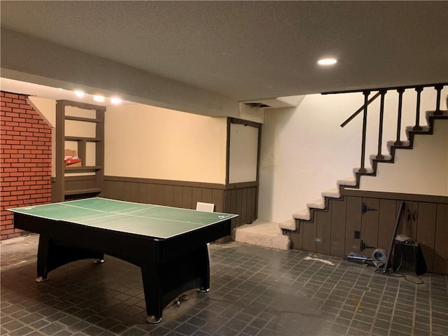 308 NW Shamrock Ave, Lees Summit, MO 64081 - game room with brick wall, wainscoting, a textured ceiling, and recessed lighting