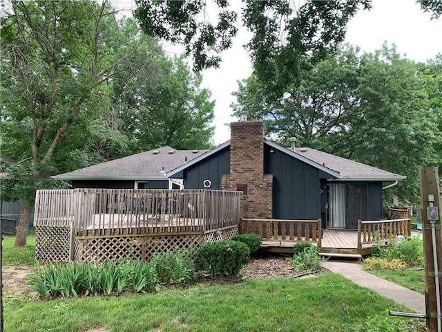 308 NW Shamrock Ave, Lees Summit, MO 64081 - back of property featuring board and batten siding, a wooden deck, a chimney, and a yard