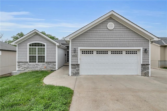 4851 NE Antioch Rd, Kansas City, MO 64119 - ranch-style home featuring a garage, a front lawn, driveway, and stone siding