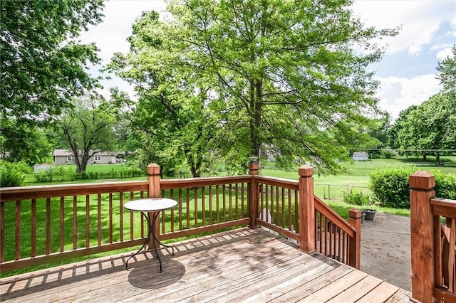wooden terrace featuring view of scattered trees