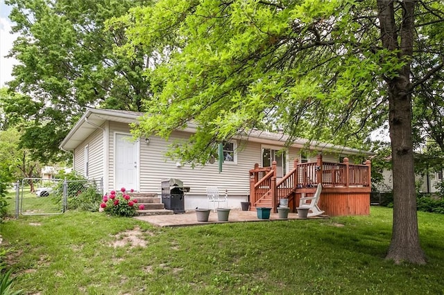 rear view of house featuring a gate, a patio area, and a wooden deck