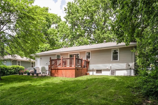 back of house with a wooden deck and a lawn