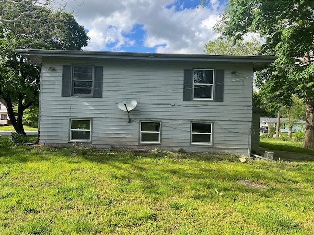 rear view of property with a lawn