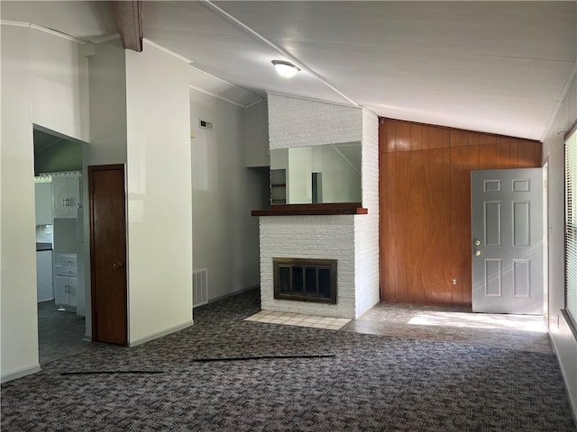 unfurnished living room with visible vents, carpet, lofted ceiling, and a fireplace