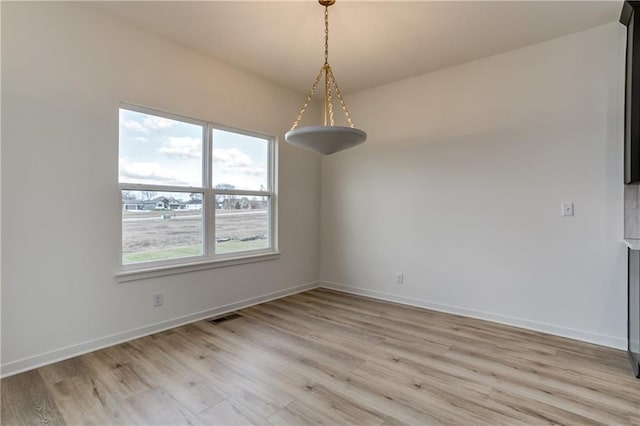 16502 S Stagecoach St, Olathe, KS 66062 - unfurnished dining area featuring light wood-style flooring and baseboards