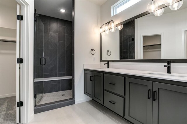 16502 S Stagecoach St, Olathe, KS 66062 - full bathroom with a shower stall, baseboards, double vanity, a walk in closet, and recessed lighting