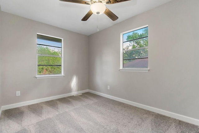spare room with baseboards, a ceiling fan, and carpet flooring