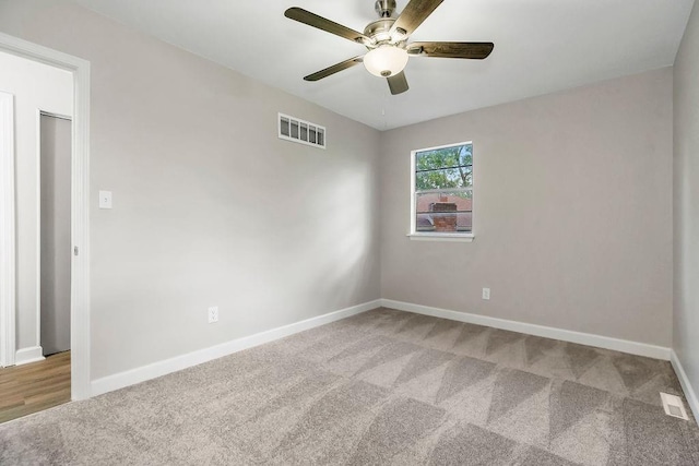 unfurnished room featuring a ceiling fan, baseboards, visible vents, and carpet