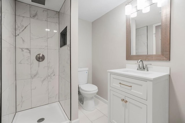 bathroom featuring vanity, toilet, and tiled shower