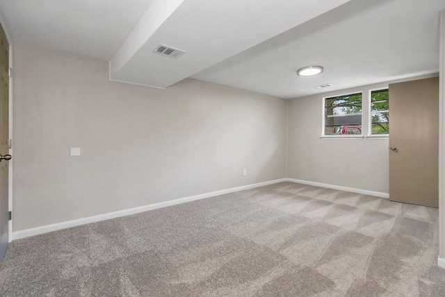 unfurnished room with carpet flooring, baseboards, and visible vents