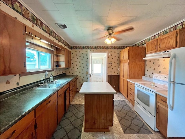 kitchen with visible vents, a center island, a sink, under cabinet range hood, and white appliances