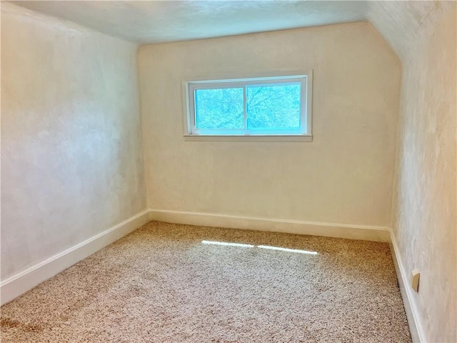carpeted empty room with baseboards