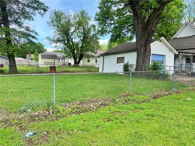 view of yard featuring fence and an attached garage