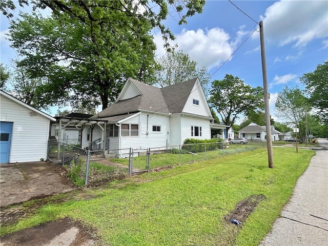 view of side of home with a lawn, a gate, fence private yard, and roof with shingles