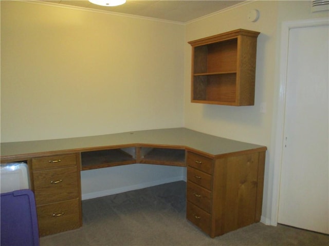 unfurnished office with carpet floors, baseboards, ornamental molding, and built in desk