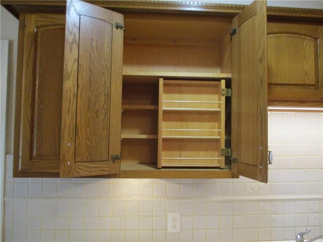 room details with decorative backsplash and brown cabinets