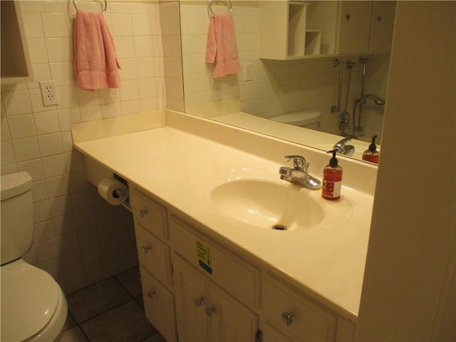 bathroom featuring tile walls, vanity, and toilet