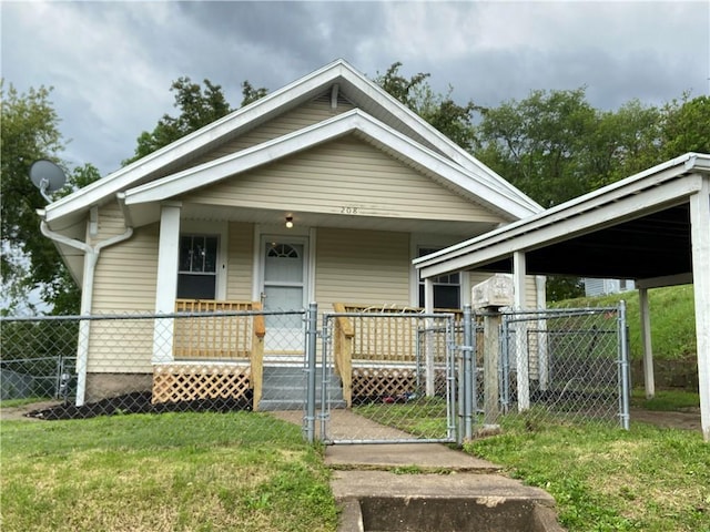 view of front of home with a porch, fence, a gate, and a front lawn