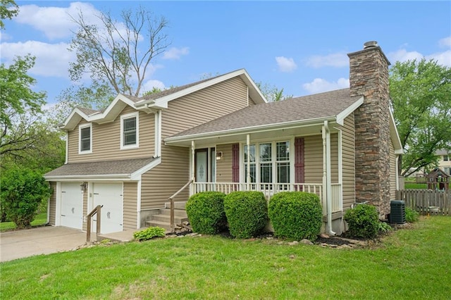 15 Baber Cir, Camden Point, MO 64018 - tri-level home featuring a chimney, concrete driveway, an attached garage, central AC unit, and covered porch