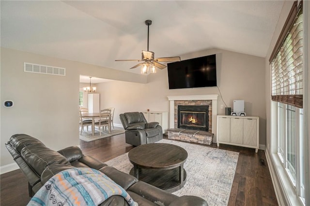 15 Baber Cir, Camden Point, MO 64018 - living room with lofted ceiling, dark wood-style flooring, a stone fireplace, a ceiling fan, and a chandelier