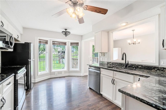 15 Baber Cir, Camden Point, MO 64018 - kitchen with appliances with stainless steel finishes, a chandelier, a sink, dark wood-style flooring, and dark stone counters