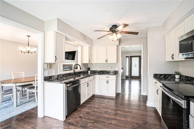15 Baber Cir, Camden Point, MO 64018 - kitchen featuring stainless steel appliances, a sink, dark wood-style floors, white cabinetry, and a chandelier
