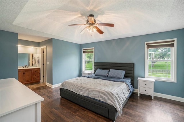 15 Baber Cir, Camden Point, MO 64018 - bedroom with a sink, baseboards, wood finished floors, a textured ceiling, and ceiling fan
