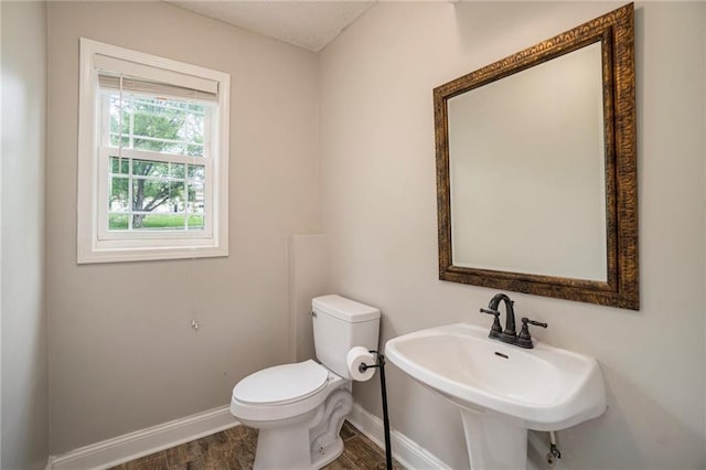 15 Baber Cir, Camden Point, MO 64018 - bathroom with toilet, baseboards, wood finished floors, and a sink