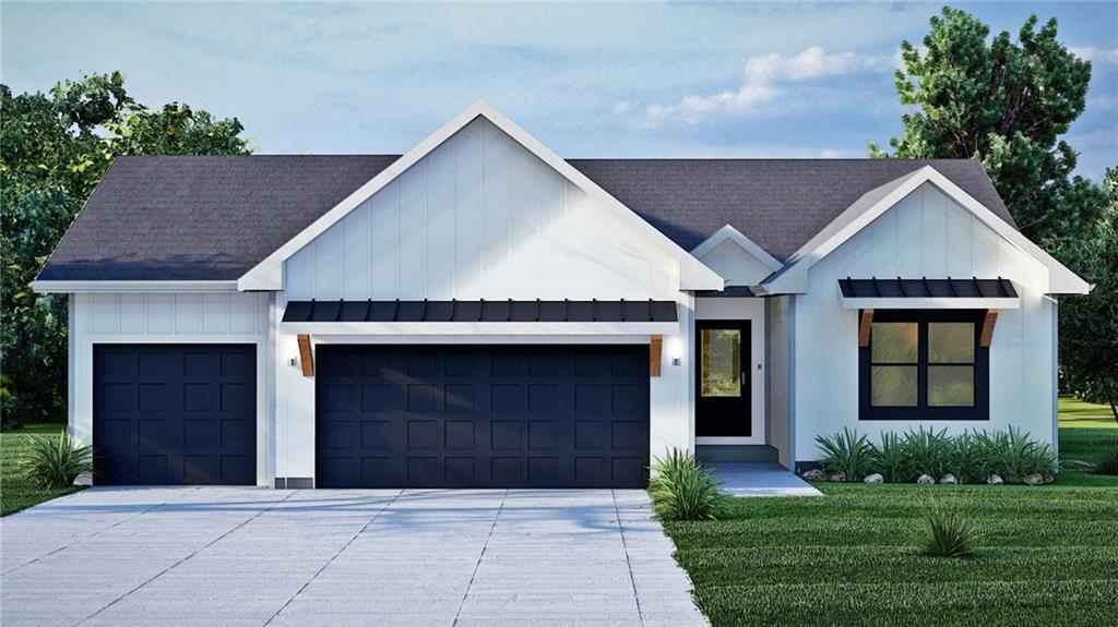 modern farmhouse featuring concrete driveway, board and batten siding, a front yard, and a garage