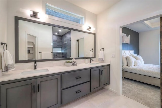 16567 S Stagecoach St, Olathe, KS 66062 - bathroom featuring tiled shower, double vanity, connected bathroom, tile patterned floors, and baseboards