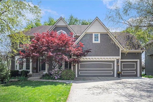 14475 Chadwick St, Leawood, KS 66224 - view of front of house featuring driveway, a front yard, and stucco siding