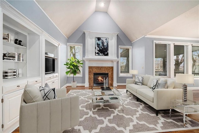 14475 Chadwick St, Leawood, KS 66224 - living room with built in features, baseboards, wood finished floors, a tile fireplace, and vaulted ceiling