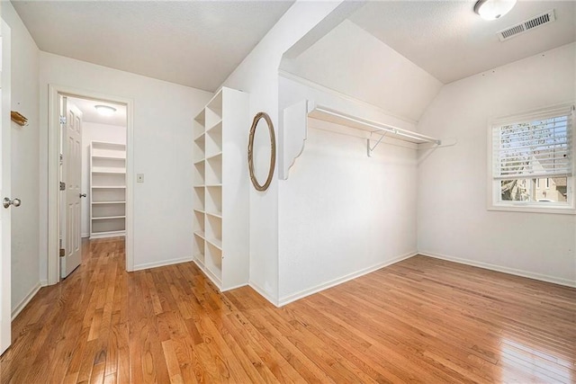 14475 Chadwick St, Leawood, KS 66224 - walk in closet featuring visible vents, light wood-style flooring, and vaulted ceiling