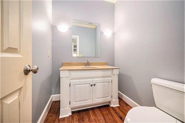 14475 Chadwick St, Leawood, KS 66224 - bathroom featuring baseboards, wood finished floors, toilet, and vanity