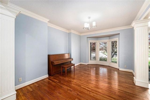 14475 Chadwick St, Leawood, KS 66224 - empty room featuring ornate columns, ornamental molding, baseboards, and wood finished floors