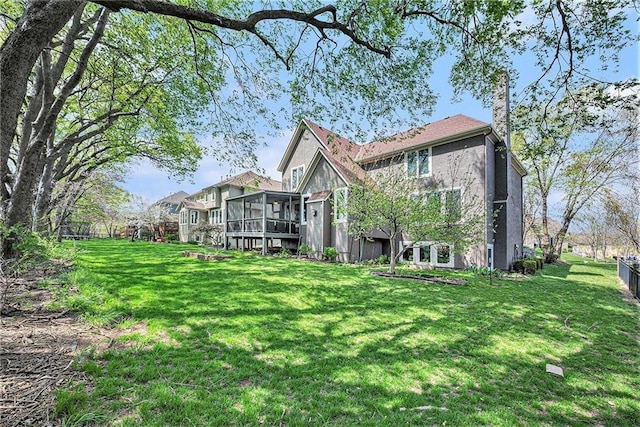14475 Chadwick St, Leawood, KS 66224 - rear view of property featuring a lawn and a sunroom