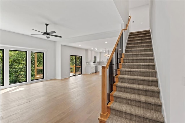 7015 Forest Lks, Parkville, MO 64152 - staircase featuring wood finished floors, a ceiling fan, recessed lighting, and baseboards