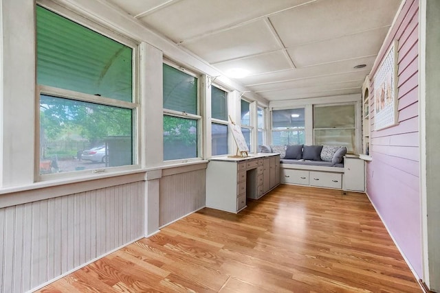 unfurnished sunroom featuring wood finished floors
