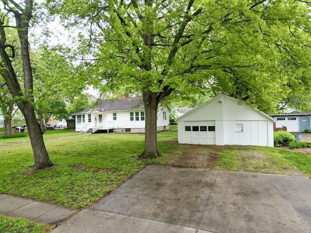 ranch-style house with a garage, an outdoor structure, and a front yard