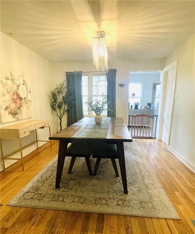 336 E Park St, Olathe, KS 66061 - dining space featuring a chandelier, wood-type flooring, and baseboards
