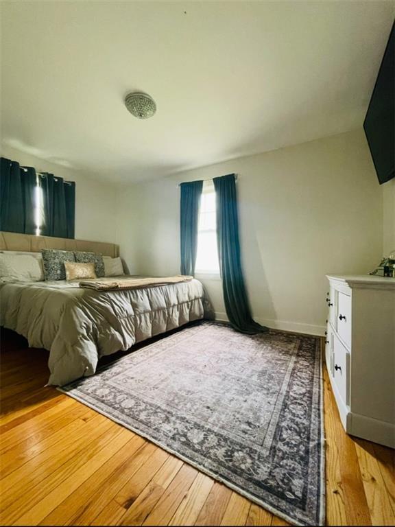 336 E Park St, Olathe, KS 66061 - bedroom featuring wood-type flooring and baseboards