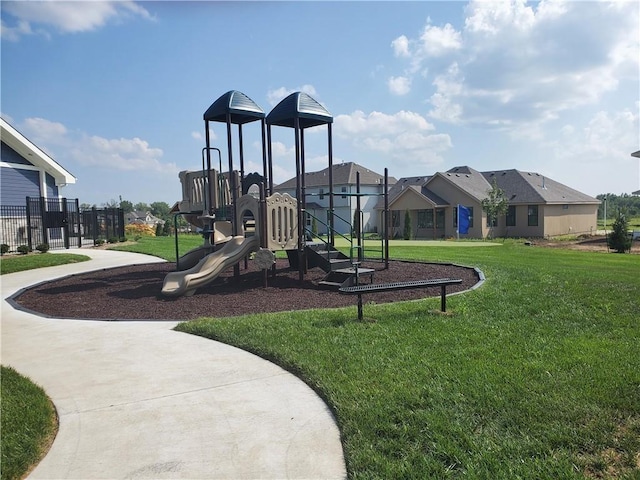 community play area with a lawn and a residential view