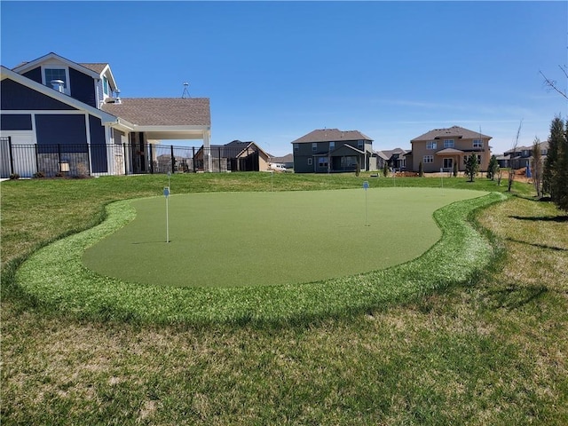 view of home's community featuring a lawn, fence, and a residential view