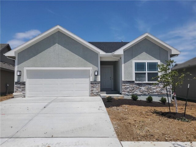 17122 W 168th Pl, Olathe, KS 66062 - ranch-style house featuring a garage, stone siding, stucco siding, and concrete driveway