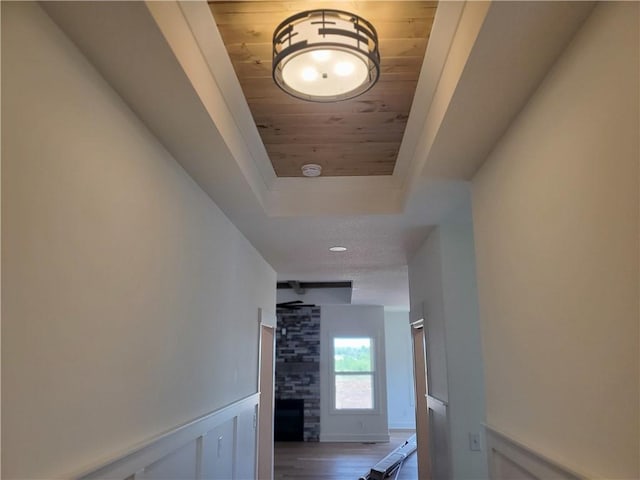 17122 W 168th Pl, Olathe, KS 66062 - hallway with wood ceiling, a tray ceiling, and wood finished floors