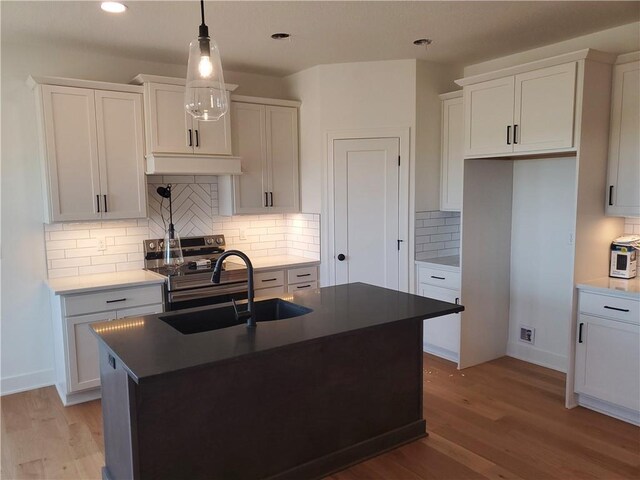 17122 W 168th Pl, Olathe, KS 66062 - kitchen featuring stainless steel range with electric stovetop, light wood-type flooring, tasteful backsplash, white cabinetry, and recessed lighting