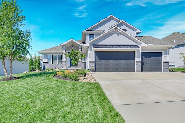 view of front of home featuring an attached garage, concrete driveway, a front yard, stone siding, and a standing seam roof