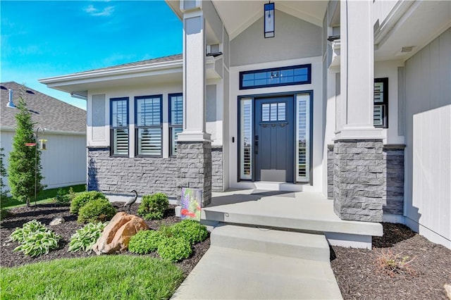 property entrance featuring covered porch and stone siding