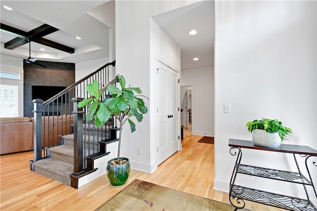 entrance foyer with wood finished floors, recessed lighting, stairs, baseboards, and coffered ceiling